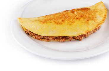 Delicious omelette filled with minced meat lying on a plate