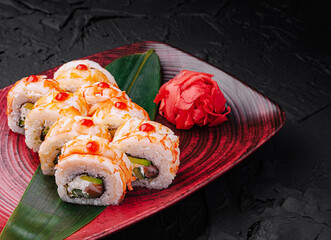 Colorful sushi rolls garnished with wasabi and pickled ginger