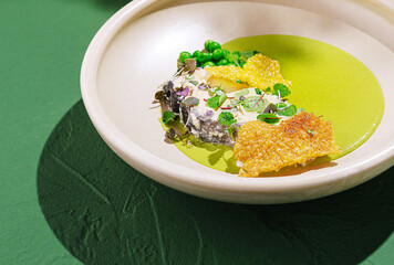 Exquisite dish featuring crispy elements and vibrant green sauce