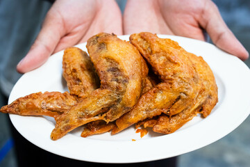 Thai style fried chicken marinated in fish sauce  in white plate.