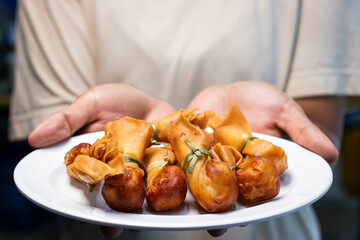 Toong thong, Thai food, Deep fried wontons filled with prawn and spring onion in white plate.
