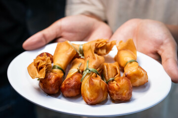 Toong thong, Thai food, Deep fried wontons filled with prawn and spring onion in white plate.