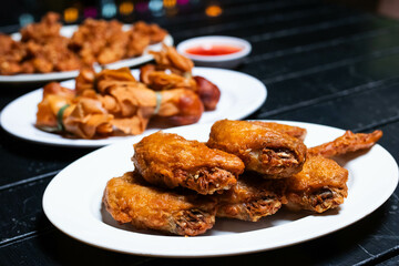 Thai style fried chicken marinated in fish sauce  in white plate.