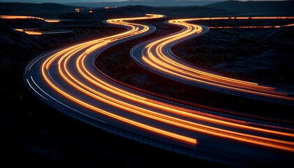 Illuminated vehicle trails curve across a dark expansive highway scene