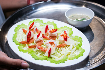 Cooked shrimp soaked in fish sauce spicy in white plate, salty and sour Thai appetizers.