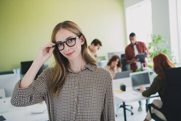 Photo of smiling happy web designers working cool startup together indoors workplace workstation