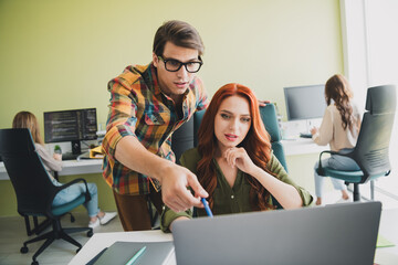 Photo of young age woman listen her boss explain how this computer program working crm system instructions indoors office