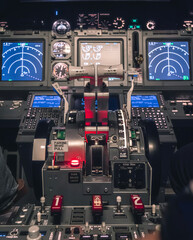 Cockpit view of an airplane during a night-time flight with illuminated instrument panels