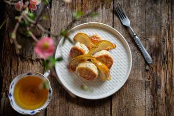 Poppy seed Syrniki with caramelized pear. Top view.	
