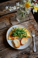 Omelette with arugula and toasted bread.