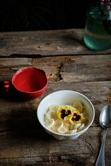cottage cheese with banana decorated with edible flowers.	