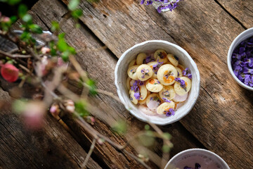 Mini pancakes with cream sauce decorated with wild violets. Spring.