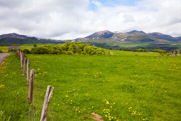 Rural landscape in the Puy-de-Dôme region. Puy de Sancy, highest peak of the massif central and Puy de l'Angle in background.