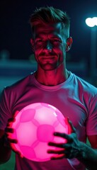 Naklejka premium Close-up of Caucasian male athlete holding illuminated football with vibrant pink light, Caucasian American male, gridiron football , sports close-up