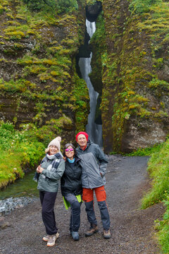 Tourists posing at gljufrabui waterfall in iceland