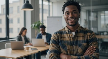 Fototapeta premium Creative Designer Working at Startup Business Agency, Smiling with Crossed Arms in Modern Office with Colleagues Collaborating on Digital Projects, Innovation, and Business Success