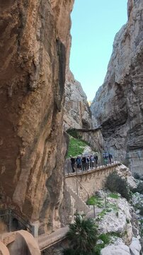  02.02.2025 Caminito del Rey (The King Walkway), Malaga, Andalusia, Spain. Hiking along scenic cliffside path with group of explorers in natural canyon. Walkway and wooden bridges. 