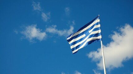 Waving Greek Flag Against Clear Blue Sky with Soft Clouds