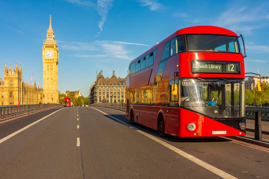 Red double-decker bus on Westminster bridge and Big Ben tower, London, UK
