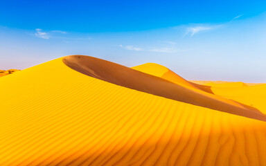 Scenic view of desert in Liwa against blue sky