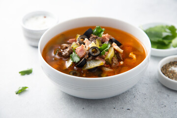 Meat soup with gherkins and olives