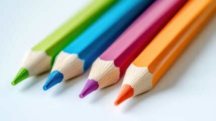 Close-up of four brightly colored sharpened pencils on white background