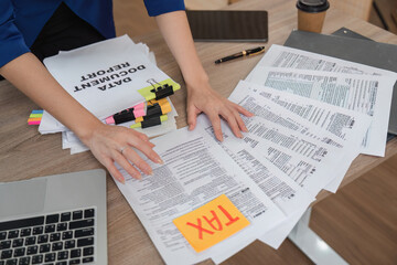 Naklejka premium Accountant organizing tax documents and financial reports on a desk
