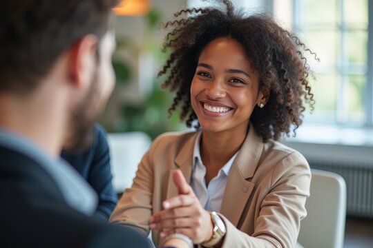 Portrait of a 30-Year-Old Black Woman in a Business Setting, Engaging in a Professional Handshake with a Colleague During a Meeting