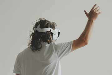 Man with long hair wearing Apple Vision Pro VR headset, one hand raised, back to camera, against neutral grey background - hyperrealistic style