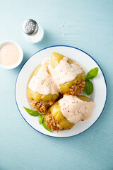 Stuffed peppers with beef, rice and sour cream sauce