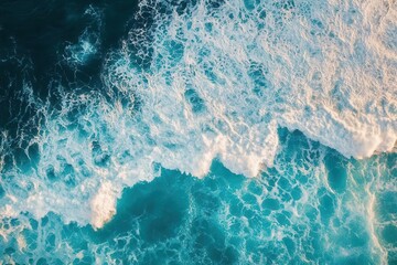Fototapeta premium sweeping aerial view of turquoise ocean waves, frothy white crests, amber sunlight dances, dynamic coastal power, vast natural rhythm, serene bird’s-eye beauty.