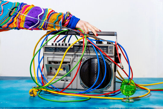 Woman touching 90s style radio cassette player