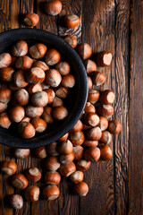 Hazelnut nuts pour out of wooden rustic table close up. Food photography