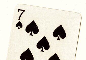 Close up of a playing card in sepia.