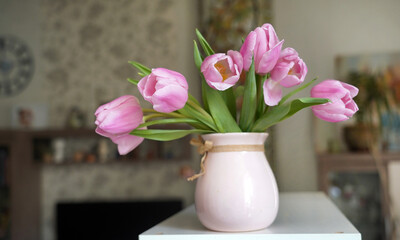 Obraz premium pink spring flowers in pink ceramic vase in modern home interior