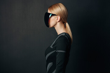 Woman wearing VR glasses with a dark background