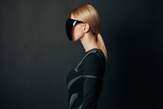 Woman wearing VR glasses with a dark background