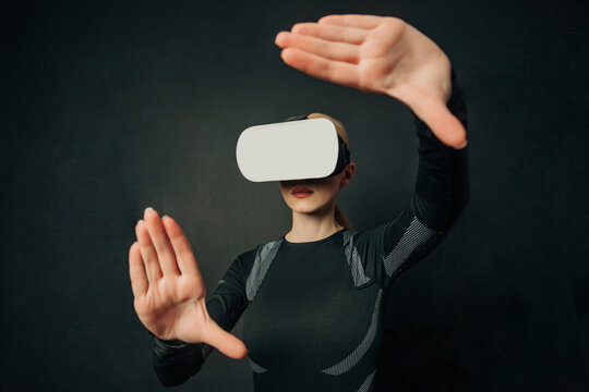 Woman using VR glasses with a dark background and interface illustration