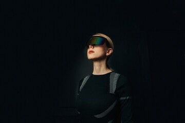 Person wearing VR glasses in a dark setting with a futuristic theme
