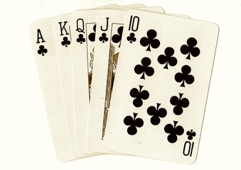 A poker hand of vintage playing cards in sepia.