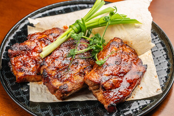hot grilled spare ribs glazed in BBQ sauce. Food recipe background. Close up. top view