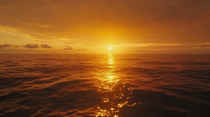 Fototapeta premium Golden ocean sunset reflecting warmth across tranquil sea horizon