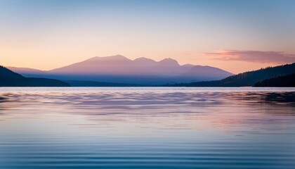 Fototapeta premium Macro calm lake surface: small ripples, distant mountains, soft cool color. Serene nature vista