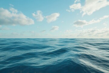Obraz premium The ocean is calm and blue, with a few clouds in the sky. The water is still, and the sky is clear