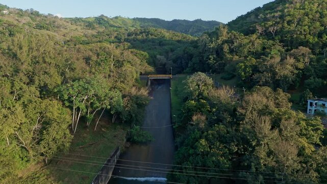Drone dolly-in over Hatillo Dam, Cotu&iacute;, Dominican Republic, surrounded by tropical forest