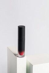 Mockup of black blank thin tube - mascara, lip gloss, gel, eyeliner, oil, etc. Cosmetic package with stylish props on white background.