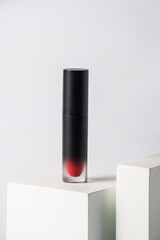 Mockup of black blank thin tube - mascara, lip gloss, gel, eyeliner, oil, etc. Cosmetic package with stylish props on white background. 