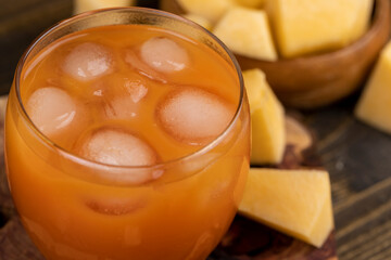 pumpkin juice in a glass and sliced ripe pumpkin