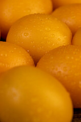 a large number of ripe orange tomatoes that are on the table