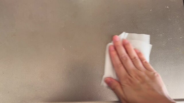 Wet Wipe Cleaning Dirty Stainless Steel Countertop in Kitchen